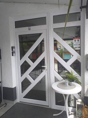 a white door with a table in front of it at Apartments Krapinske Toplice Krtak Biba in Krapinske Toplice