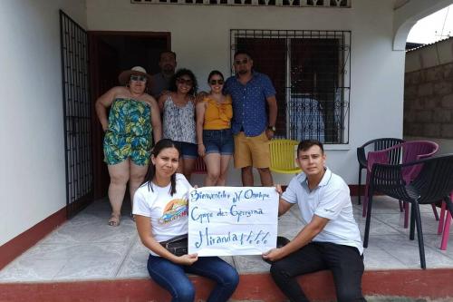 a group of people posing for a picture with a sign at Casa y Hospedaje Norma in Moyogalpa