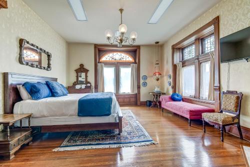 a bedroom with a bed and a couch and a table at The Bressmer in Springfield