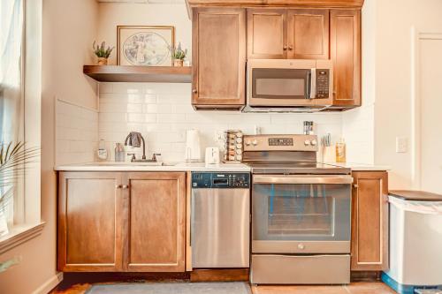 a kitchen with wooden cabinets and stainless steel appliances at The Bressmer in Springfield