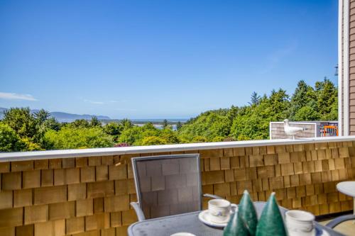 a view from the balcony of a house with a table and chairs at Netarts Lookout - Meredith Lodging in Netarts