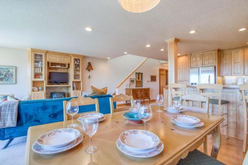a dining room with a table with wine glasses on it at Netarts Lookout - Meredith Lodging in Netarts