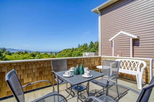 a patio with a table and chairs on a balcony at Netarts Lookout - Meredith Lodging in Netarts