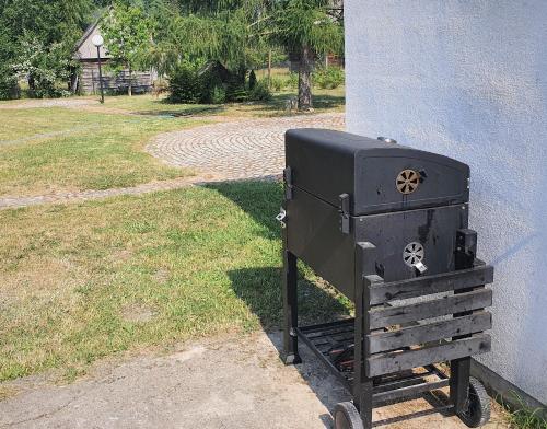 a black stove sitting on the side of a building at Podlaski Zakątek in Bereżyszcze