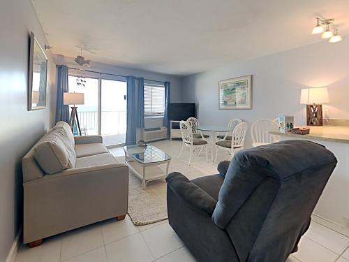 a living room with a couch and a chair and a table at Perdido Skye #22 in Perdido Key