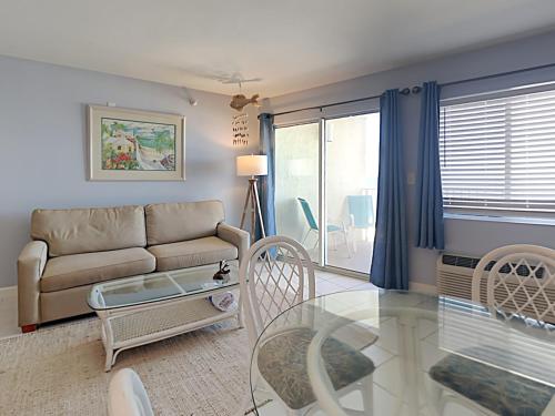 a living room with a couch and a glass table at Perdido Skye #22 in Perdido Key