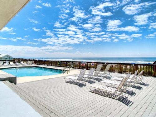 a group of lounge chairs sitting next to a swimming pool at Perdido Skye #22 in Perdido Key