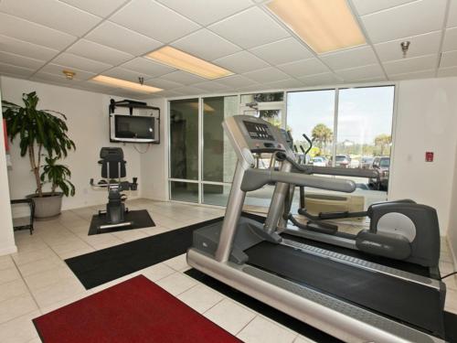 a gym with a treadmill and a tv in a room at Perdido Skye #22 in Perdido Key