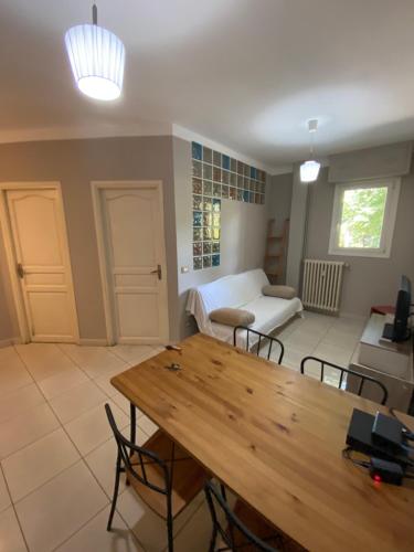 a living room with a wooden table and a couch at Loryhouse in Menton