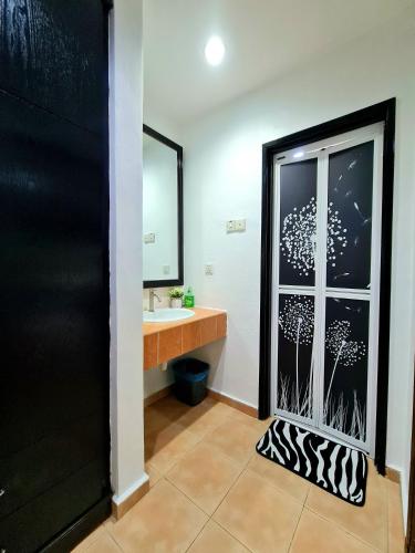 a bathroom with a window with a sink and a mirror at Private 4Bedroom Villa Pool,BBQ,Karaoke, Afamosa Resort in Kampong Alor Gajah
