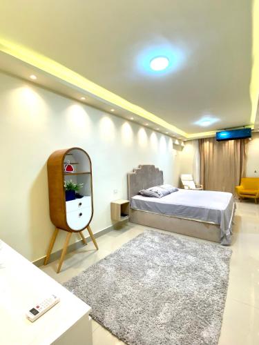 a bedroom with a bed and a mirror at Hyat Apartments in Alexandria