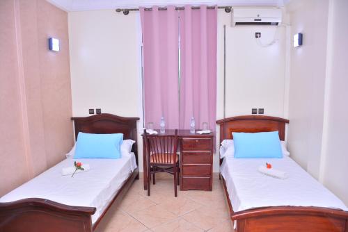 Ein Bett oder Betten in einem Zimmer der Unterkunft Hôtel Elfekri