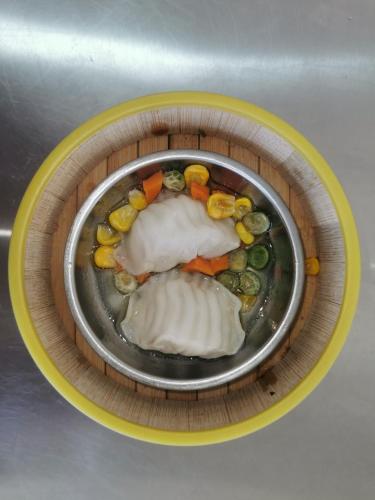 a bowl of food with meat and vegetables on a plate at ฺBaan Rai Ing Doi in Chaiyaphum
