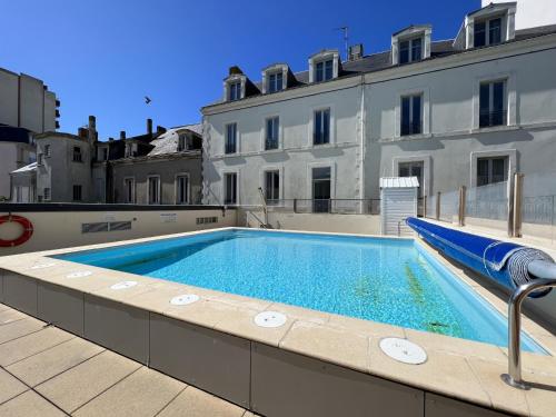 une piscine sur le toit d'un immeuble dans l'établissement Appartement avec aperçu mer et piscine aux Sables-d'Olonne - FR-1-485-137, à Les Sables-dʼOlonne
