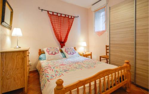 a bedroom with a large bed and a window at 1 Bedroom Cozy Apartment In Zonza in Zonza