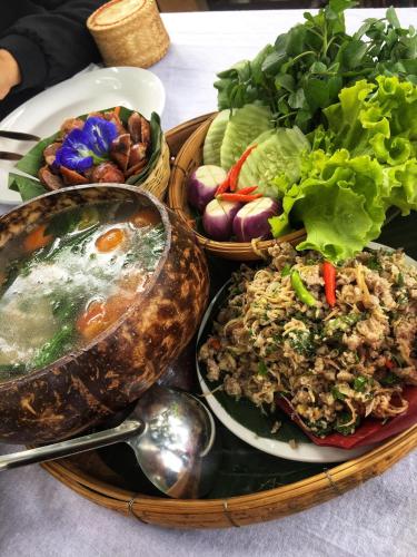 a table with three plates of food on a table at On The Mekong Resort in Luang Prabang