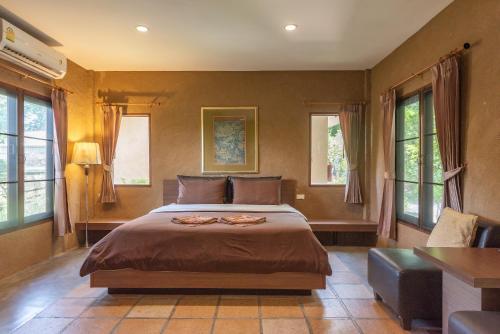 En eller flere senger på et rom på Muntra Garden Resort