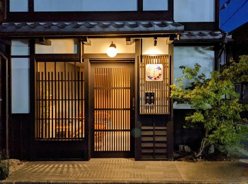 a front door of a house with a sign on it at Kyoyado Heianshiki in Kyoto