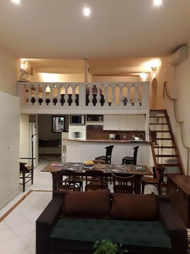 a kitchen and living room with a table and chairs at L'anthurium de l'Opéra in Nice