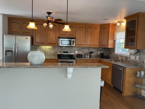 a kitchen with wooden cabinets and stainless steel appliances at The Cypress Inn in Conway