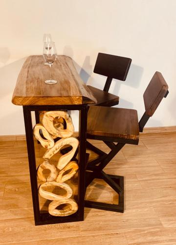 a table with a glass of wine and a pile of pretzels at Apartamentos Plaza de la Independencia in Zipaquirá