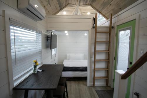 a tiny house with a table and a bed at Teton Peaks Resort in Tetonia