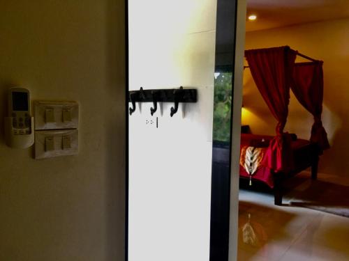 a door with a mirror in a room at Naraya Homestay in San Pa Tong