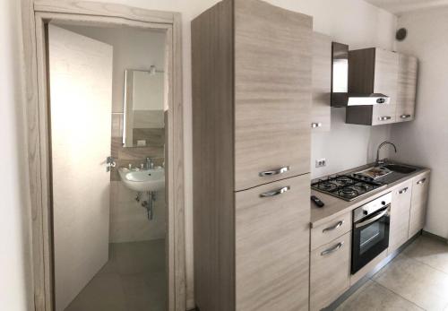 a small kitchen with a sink and a stove at Quintino Apartments Pool in Torre Lapillo
