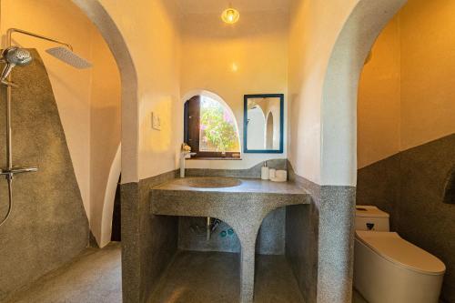 a bathroom with a sink and a shower and a toilet at Flow House 3BR Beachfront An Bang Beach Hoi An by Beachside Boutique Homes in An Bàn (2)
