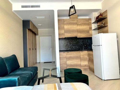 a living room with a couch and a refrigerator at Dream Apartment Tsaghkadzor in Tsaghkadzor