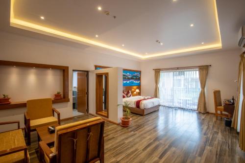 a large room with a bed and a large window at Manigram Bishram Batika Pvt Ltd in Bhairahawa
