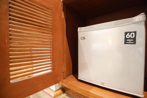 a room with a wooden window and a appliance at Manigram Bishram Batika Pvt Ltd in Bhairahawa