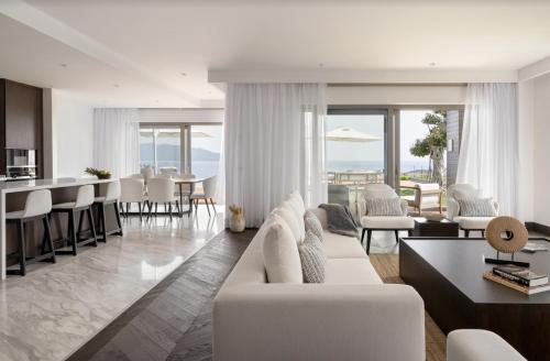 a living room with a white couch and a table at METT Hotel & Beach Resort Bodrum in Bodrum City