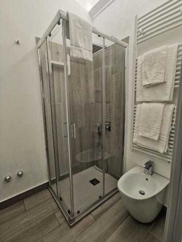 a bathroom with a shower and a toilet and a sink at Puntaalarooms in Punta Ala