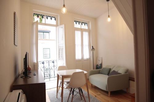a living room with a couch and a table at Sweet Love Family Double in Coimbra