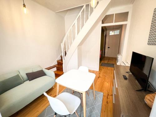 a living room with a couch and a tv at Sweet Love Family Double in Coimbra