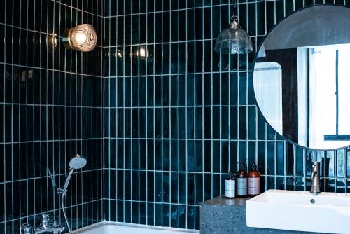 a bathroom with a sink and a mirror at karaarom hotel in Bangkok