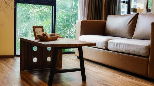 a living room with a couch and a coffee table at karaarom hotel in Bangkok