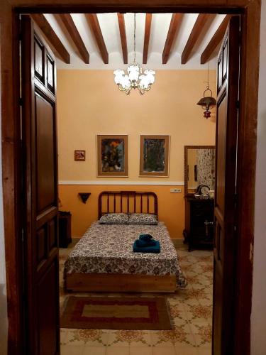 a bedroom with a bed and a chandelier at Relax y Descanso in Aspe