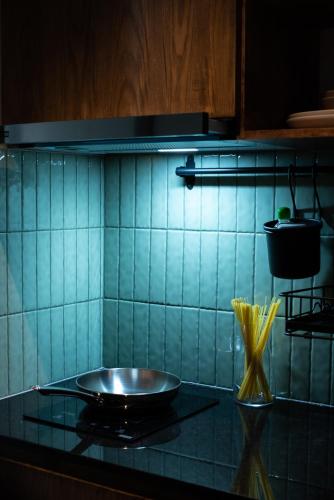 a blue tiled kitchen with a plate on a counter at karaarom hotel in Bangkok