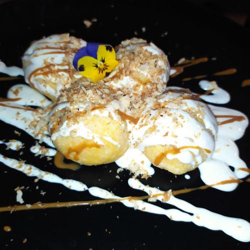 a pile of food with a flower on top of it at Gastland M1 Hotel & Conference Center in Páty