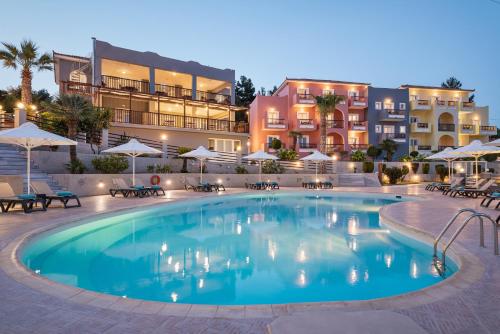 a large swimming pool in front of a building at Naftilos in Pythagoreio