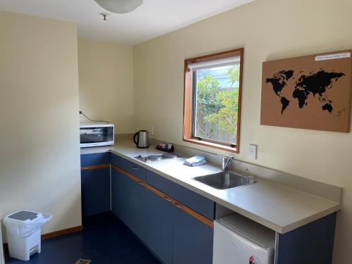 a kitchen with a sink and a window at Central Park Motor Lodge in Christchurch