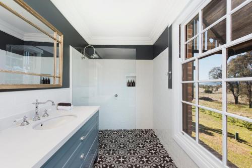a bathroom with a sink and a large window at Enfield House Mudgee in Mudgee