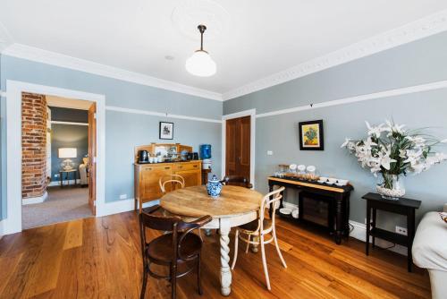 a living room with a table and a couch at Enfield House Mudgee in Mudgee