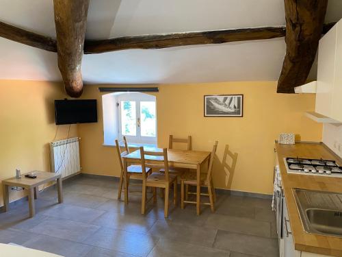 een keuken en eetkamer met een tafel en stoelen bij Villa Lucia home holiday in Carrodano Inferiore