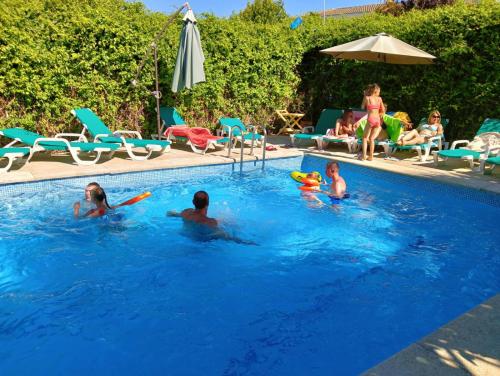 a group of people playing in a swimming pool at Residencial Playa Lisa in Boadilla del Monte