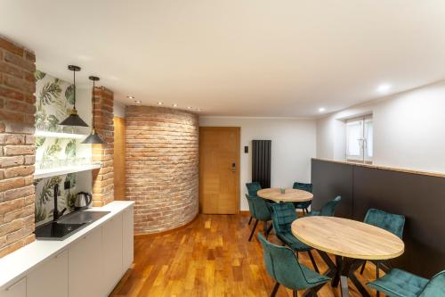 a kitchen and dining room with two tables and chairs at Apartamenty Przy Plaży Klif in Gdynia
