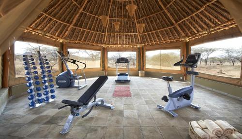a gym with several exercise bikes in a building at Severin Safari Camp in Tsavo West National Park