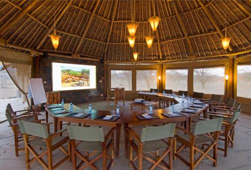 a large dining room with a large table and chairs at Severin Safari Camp in Tsavo West National Park